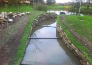 Finishing off the dry stone wall and water channel